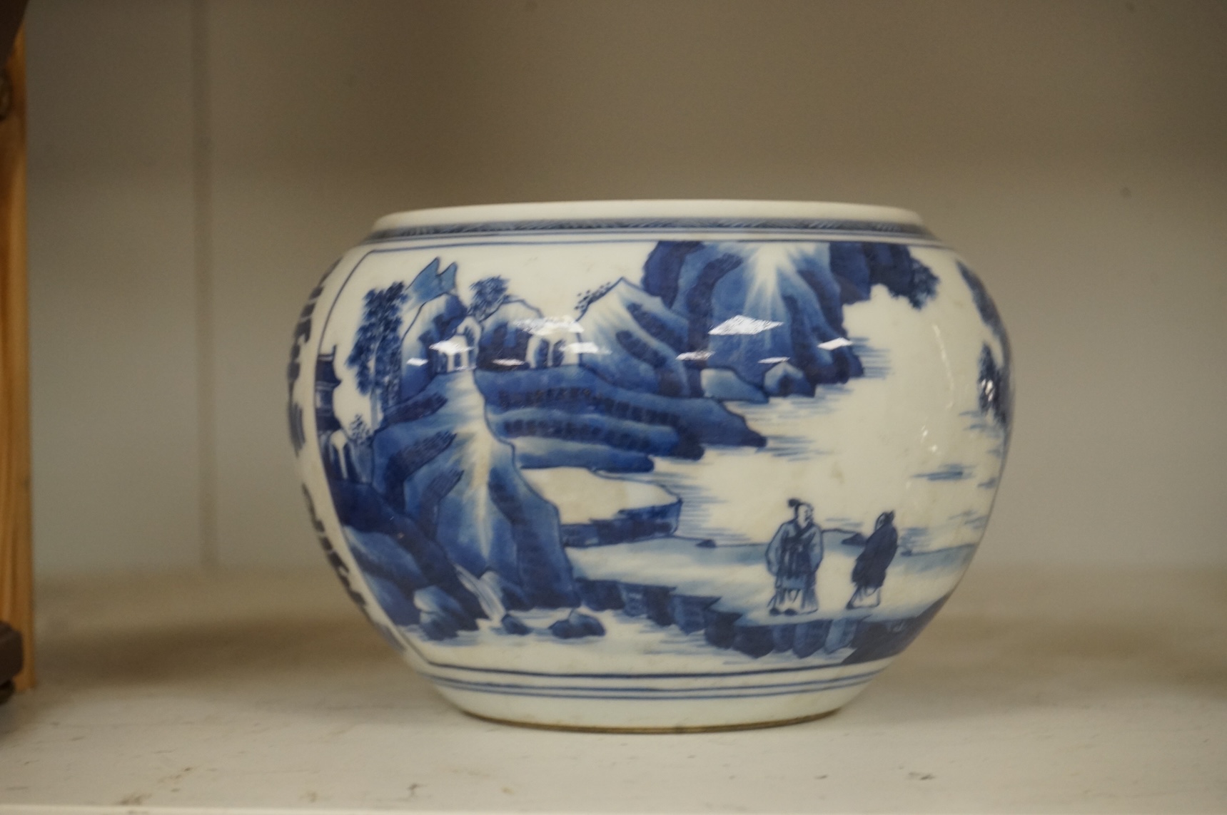 A Chinese blue and white water pot, decorated with two scenes in landscapes, 10.5cm high